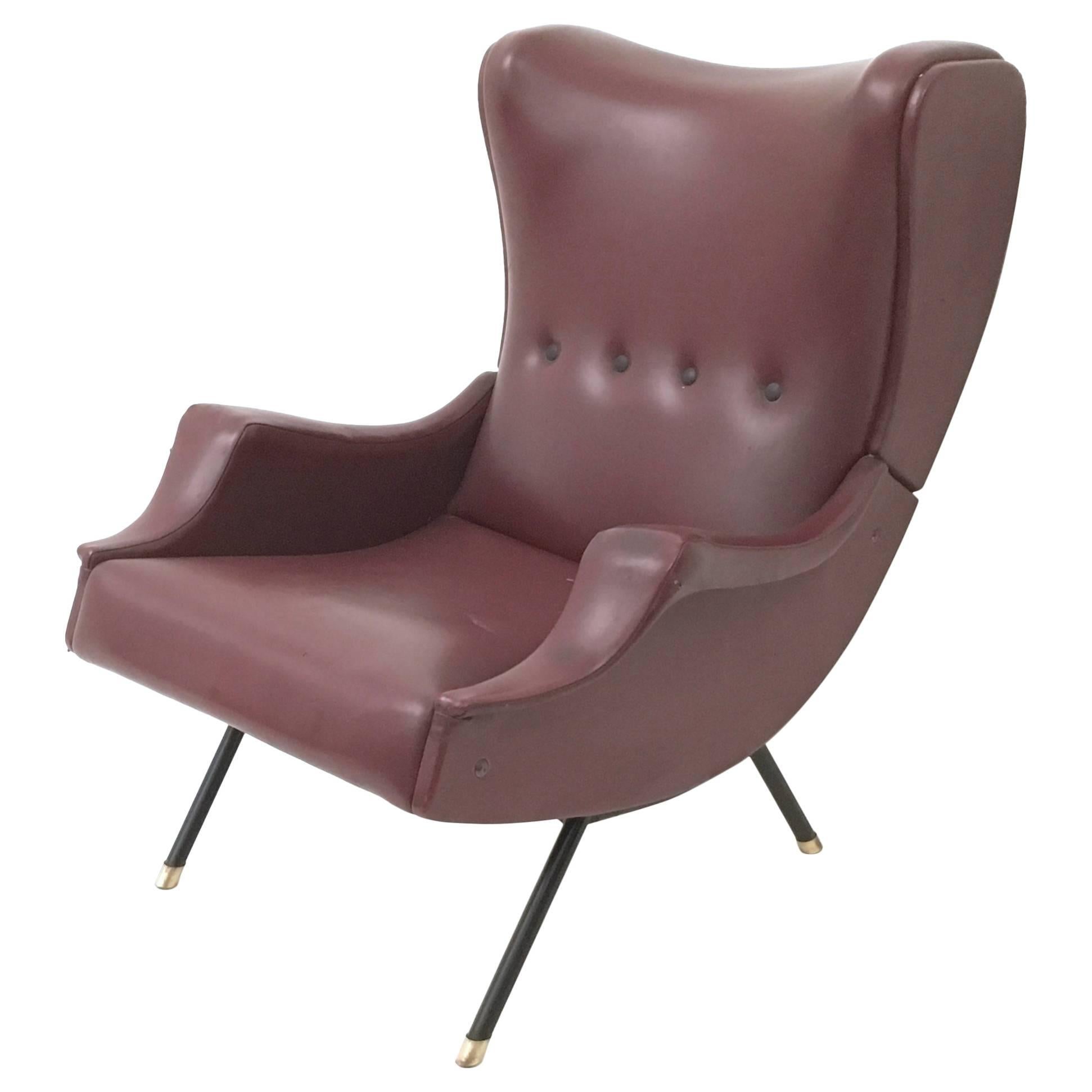Made in Italy, 1950s.
This lounge chair features a varnished metal frame with brass details and a burgundy skai upholstery.
It is a vintage piece, therefore it might show slight traces of use, but it can be considered as in very good original