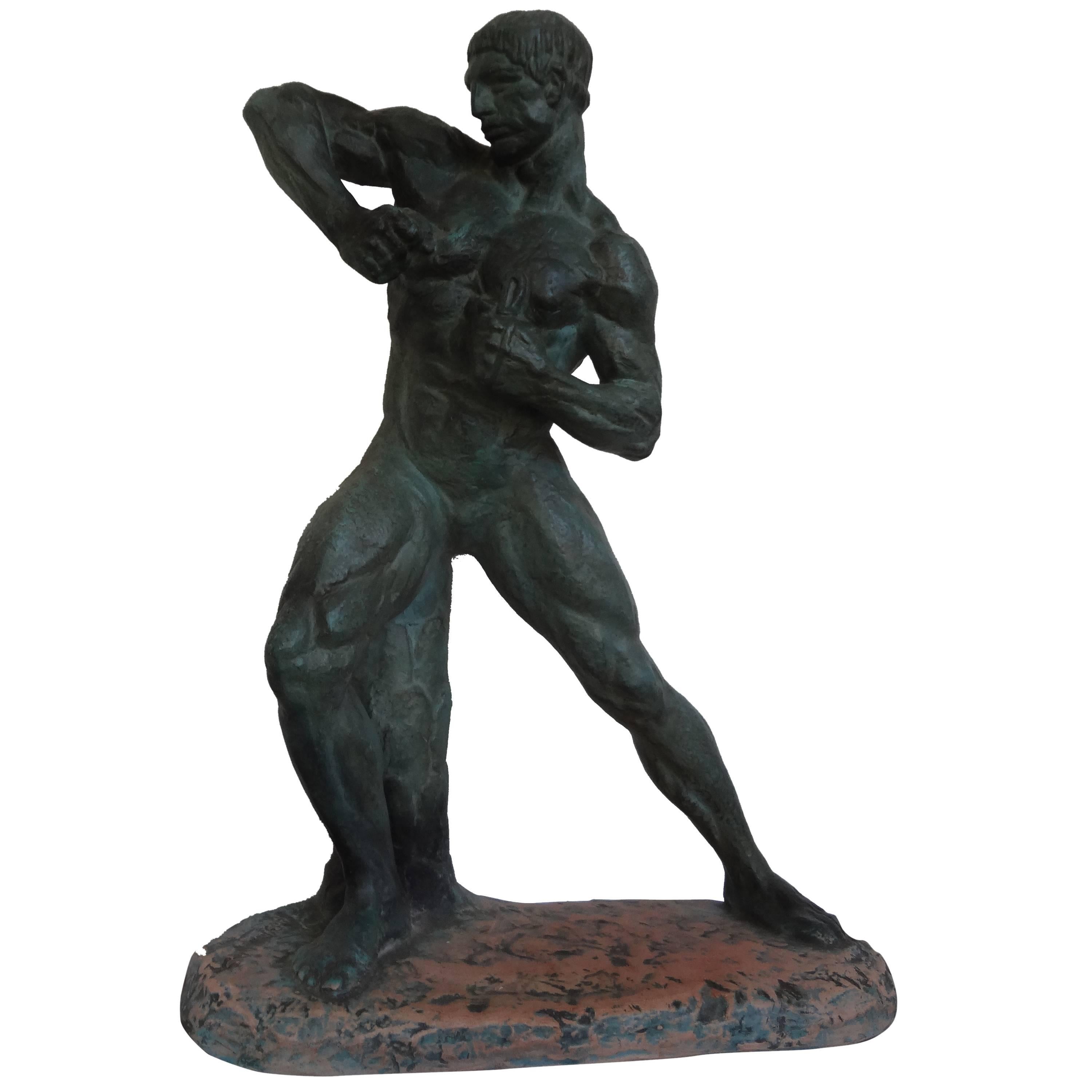 This fabulous French Art Deco patinated terracotta sculpture of a nude male athlete is signed Henri Bargas. This well executed sculpture has a patinated finish that resembles bronze and dates to the 1930s. 

Bargas exhibited at the Paris