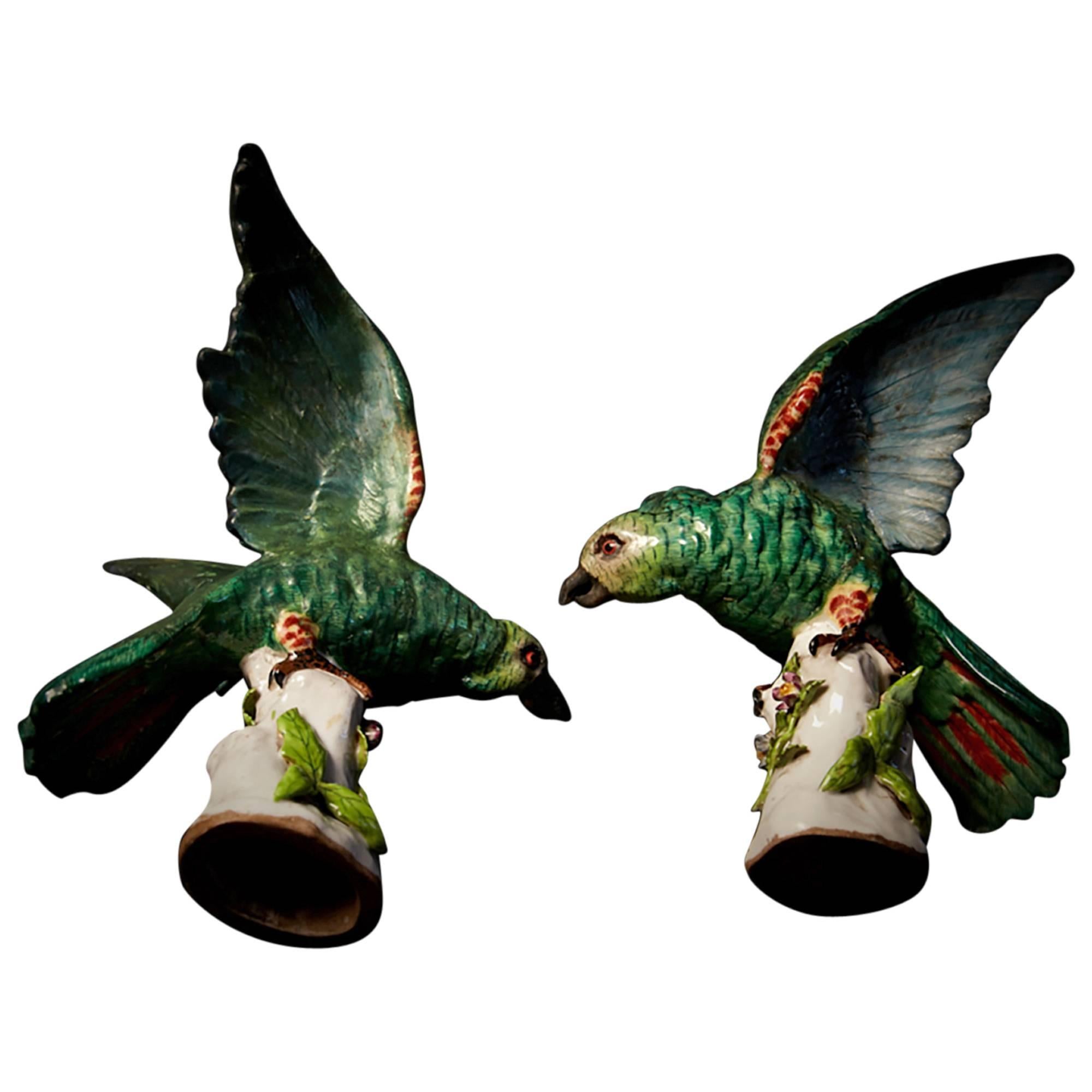 Evocative, dramatic pieces, these parrots have exceptional vitality and energy. The patina and color are quite lovely. Evidence of extensive restoration is visible, but this does not deter from their decorative value. They would look striking in any