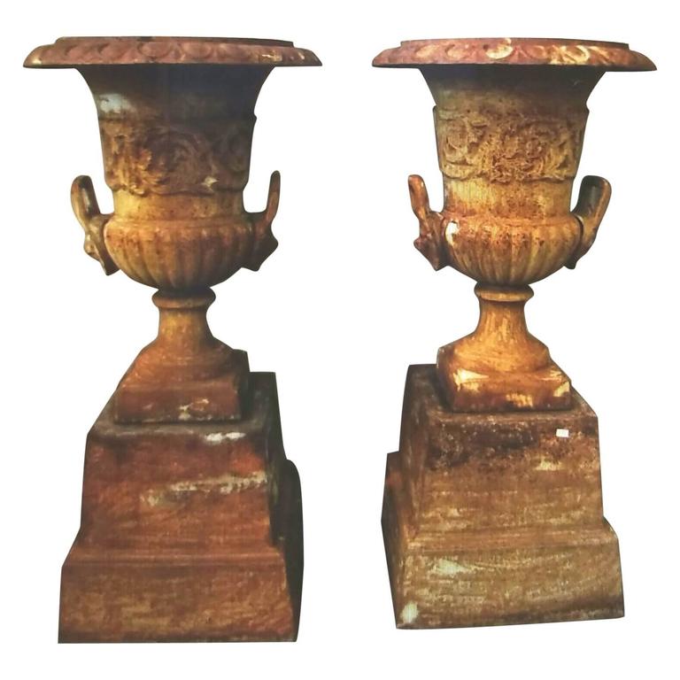 Pair of Cast Iron Urns on Pedestal with Crowned Lion's Head Handles at