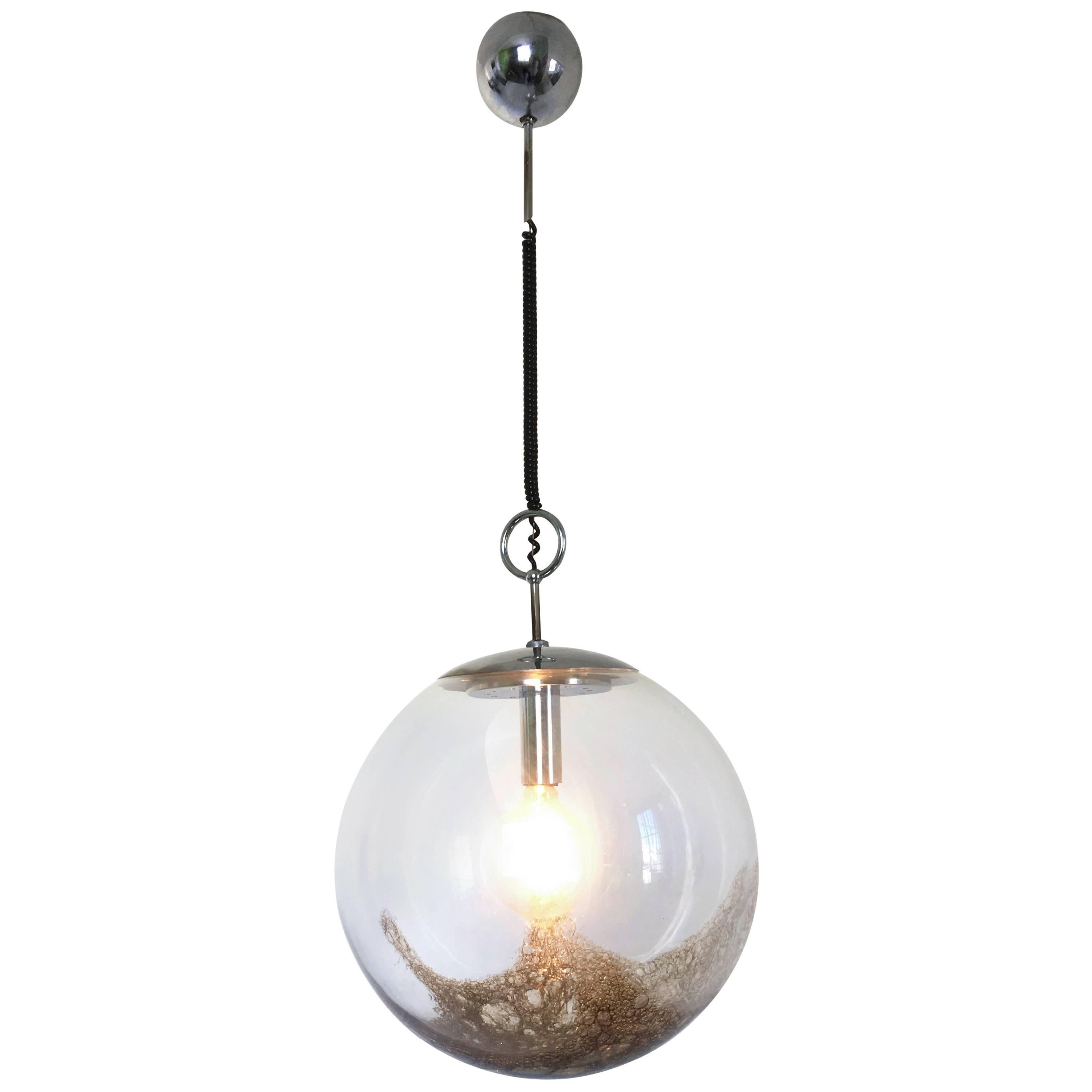 Made in Italy, 1970s. 
This large pendant light features a blown glass sphere.
It is a vintage piece, therefore it might show slight traces of use, but it can be considered as in very good original condition and ready to give ambiance to any room.