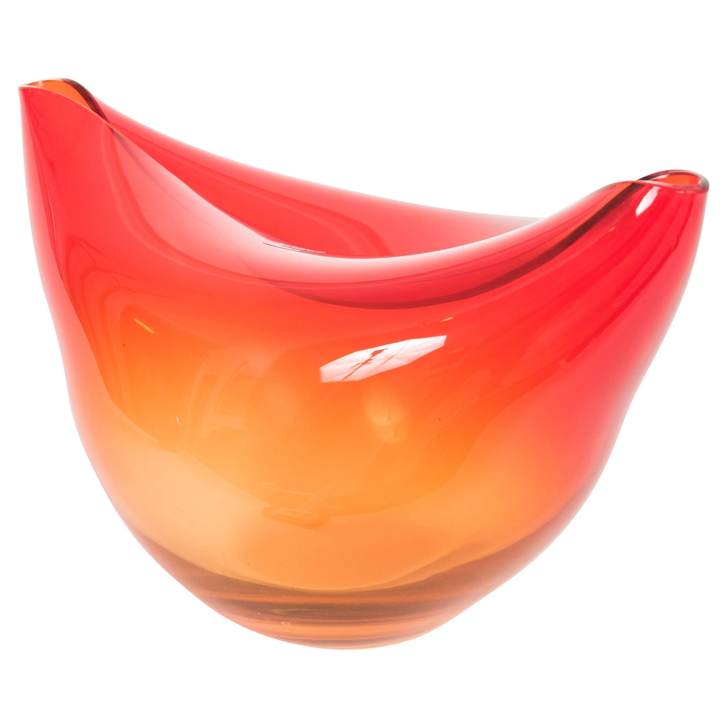 Orange glass vase organically shaped with folded sides. Engraved signature and paper label.