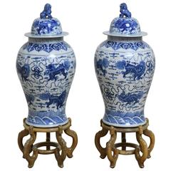 Pair of 20th Century Chinese Blue and White Porcelain Urns with Lids on Stands