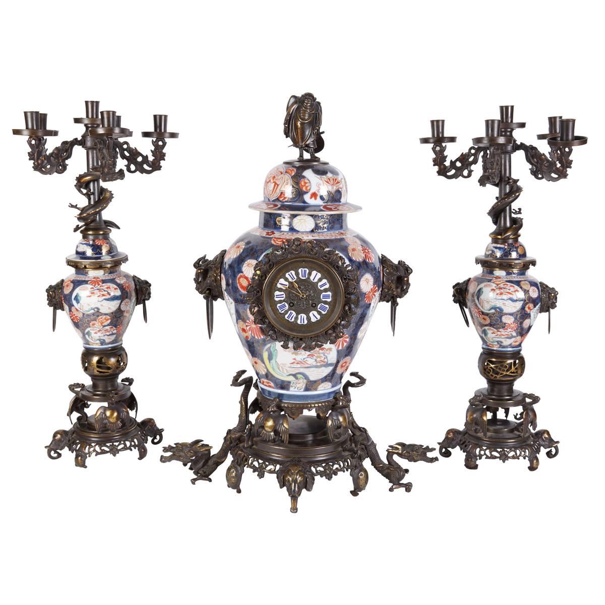 French Japonisme Parcel-Gilt Patinated Bronze Imari Porcelain Clock Garniture