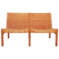 A mid-century design two-seat bench by Ejner Larsen & Aksel Bender Madsen