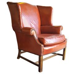 A Stately Traditional English Red Leather Wing Back Armchair With Nailhead Trim