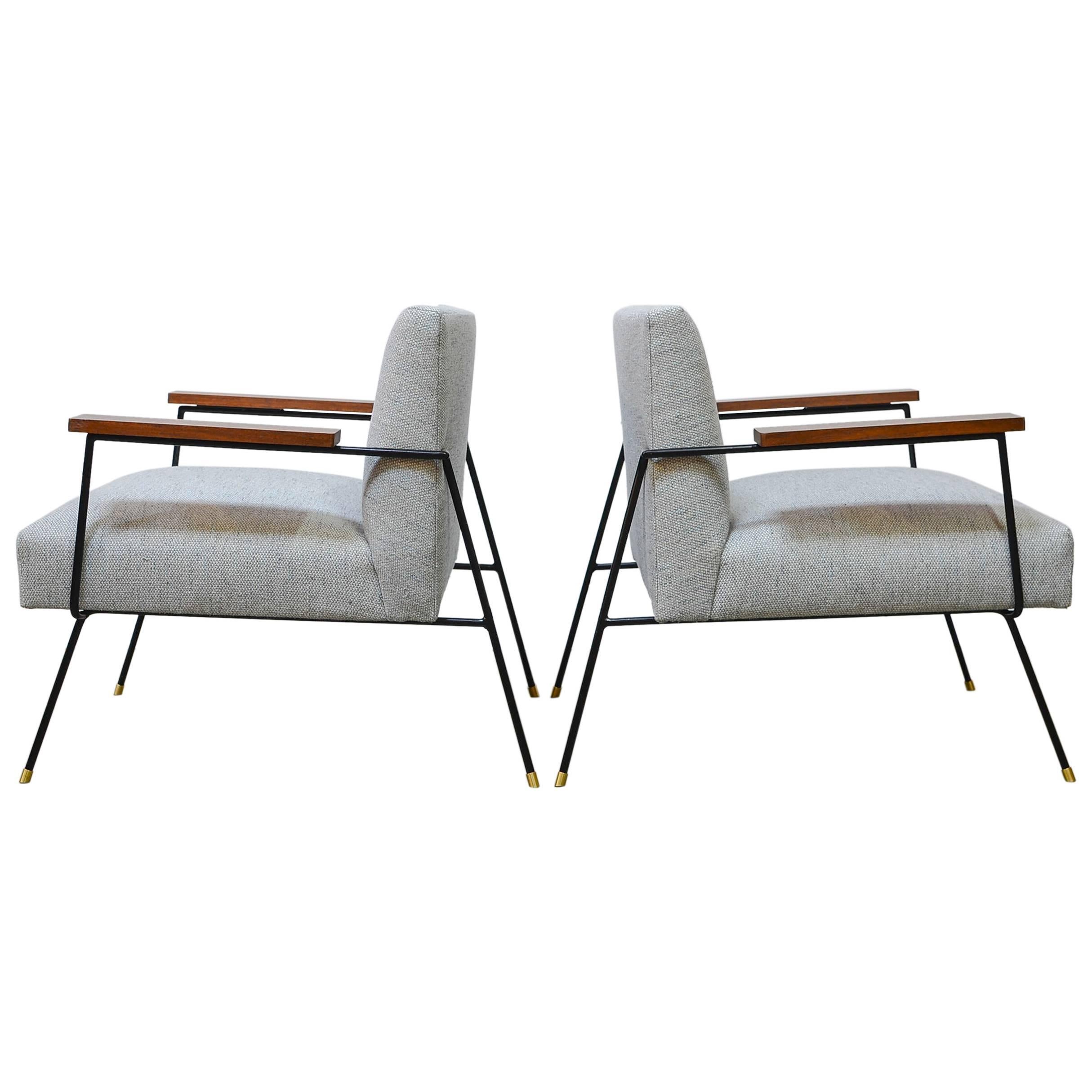 Custom iron framed lounge chairs made in house, inspired by the designs of Milo Baughman. Features an extremely comfortable upholstered floating seat consisting of springs and foam. The arm rests are made from solid walnut, and leg glides are