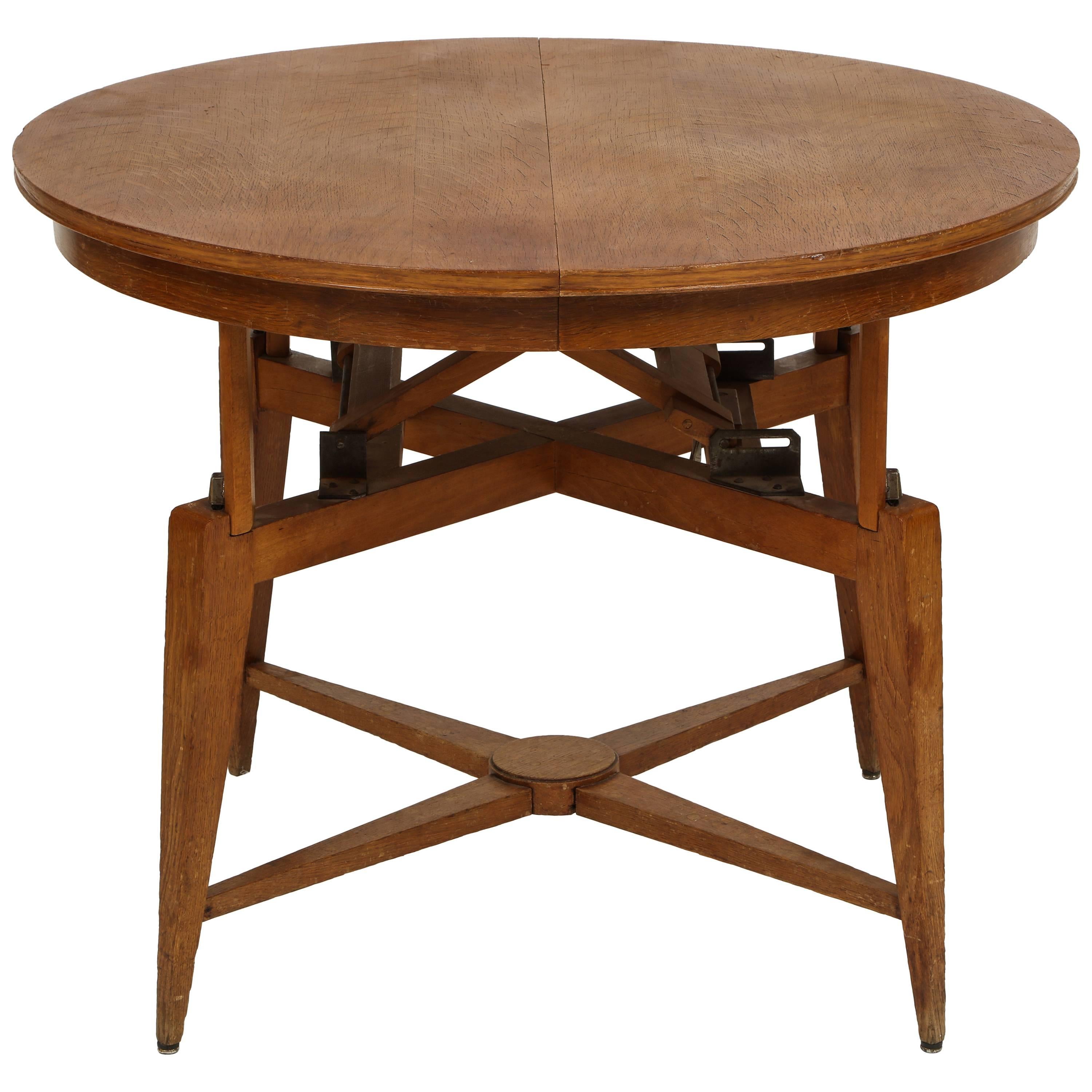 Marcel Gascoin, 1950s Wood convertible coffee center dining table midcentury, France.

Round oak table that converts from a coffee table to a dining table. Beautiful patina on the wood and incredible original mechanism. Similar to 