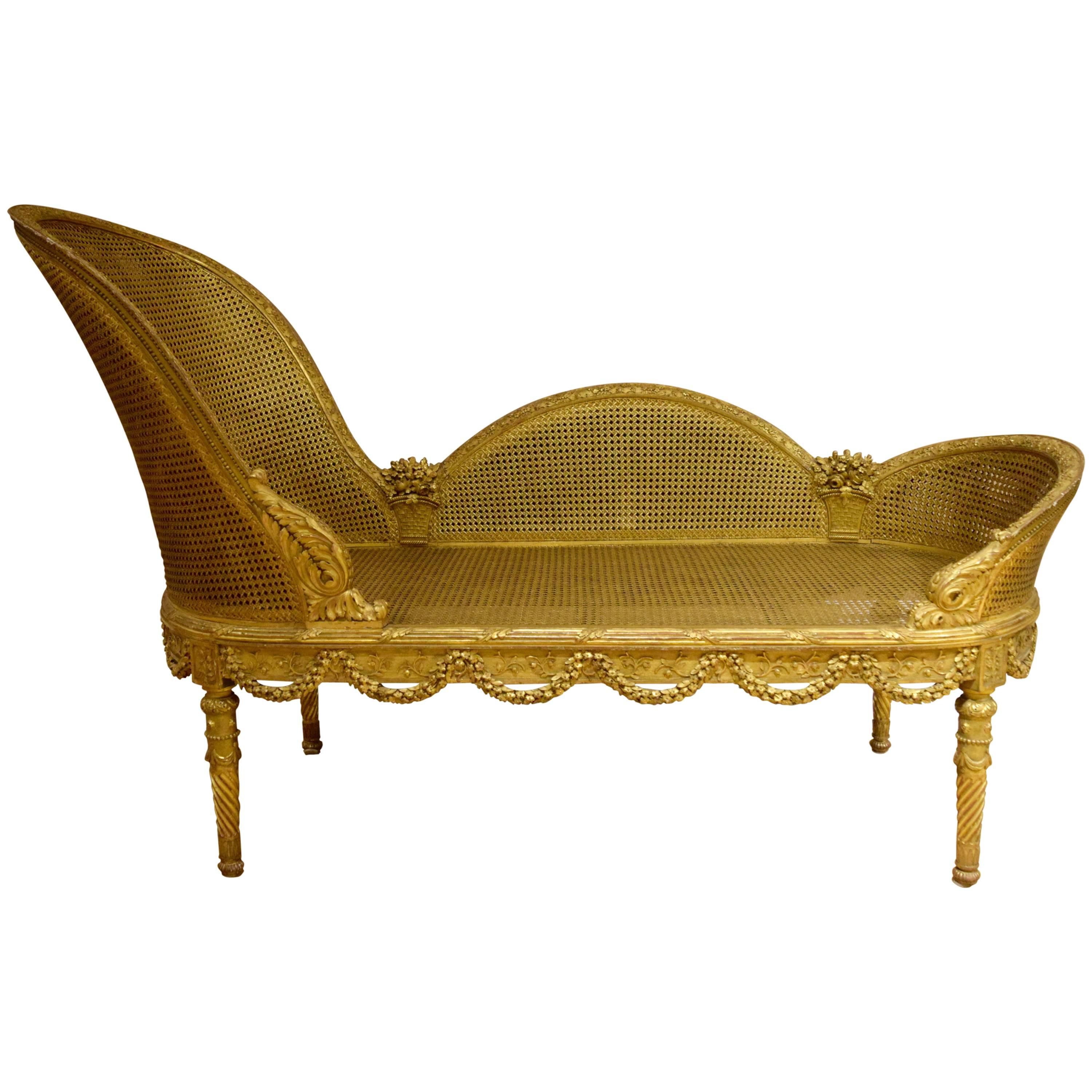 This chaise lounge is entirely gilded, and superbly carved with openwork swags and baskets brimming with flowers. The originality of the Louis XVI-inspired form speaks to the creativity of the finest Belle Epoque designers working in Paris around