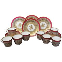 Set of Four English Gilt Coral Pattern and Magenta Porcelain Trios 