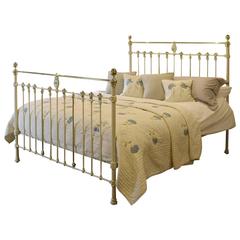 Wide Cream Bed with Brass Rosette Decoration