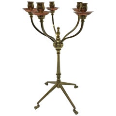W A S Benson, signed, An Arts & Crafts Brass and Copper Five Branch Candelabra