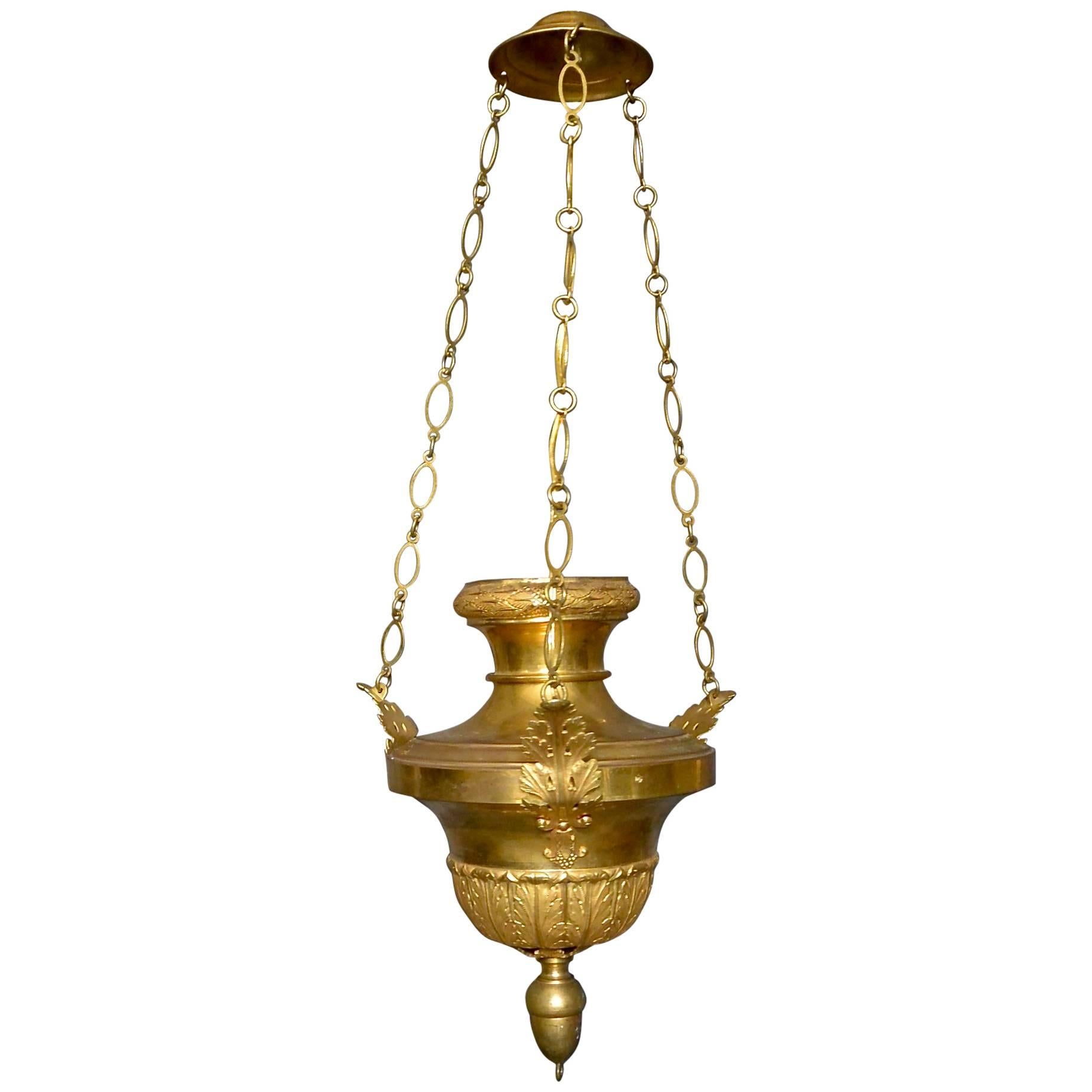 Italian Neoclassical gilt brass pendant. Italian neoclassical gilt brass pendant fixture of Louis XVI urn oil lamp form / incense burner with foliate rim and acanthus arms suspended from gilt chains terminating in an acorn finial at base. Newly