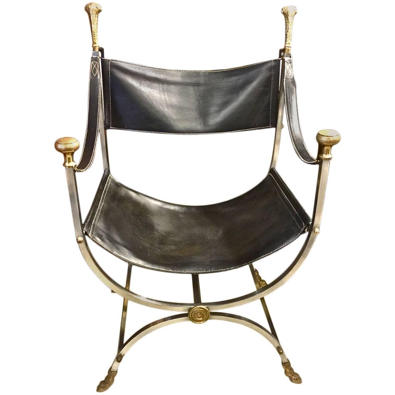 Iconic Maison Jansen steel and brass Savonarola chairs dating to 1960-70. The chair is in excellent condition and retains its original black leather upholstery. The polished steel,
as well as the brass adornments, are in very good condition. The
