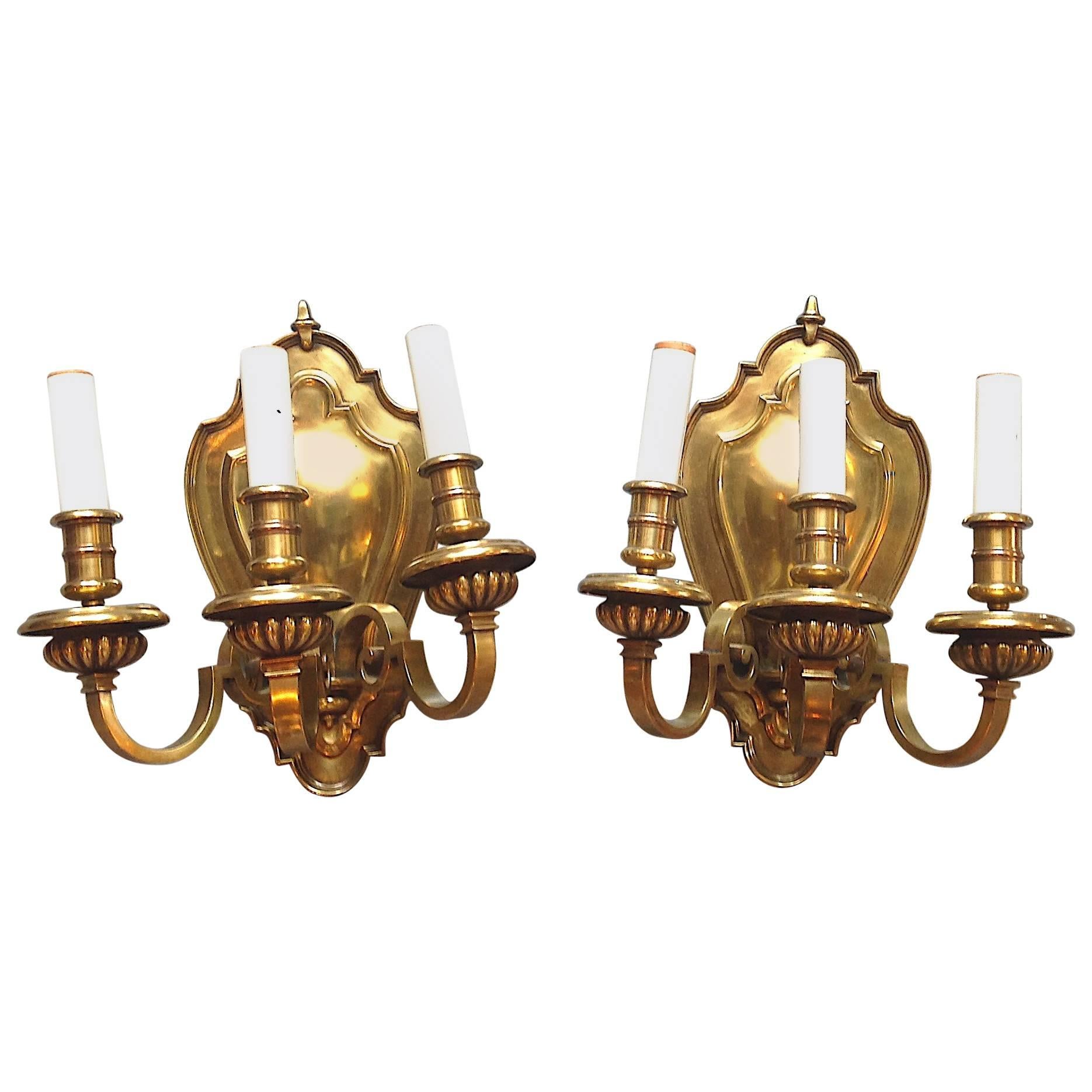 Pair of Three-Light Cast Brass Shield Back Wall Sconces For Sale