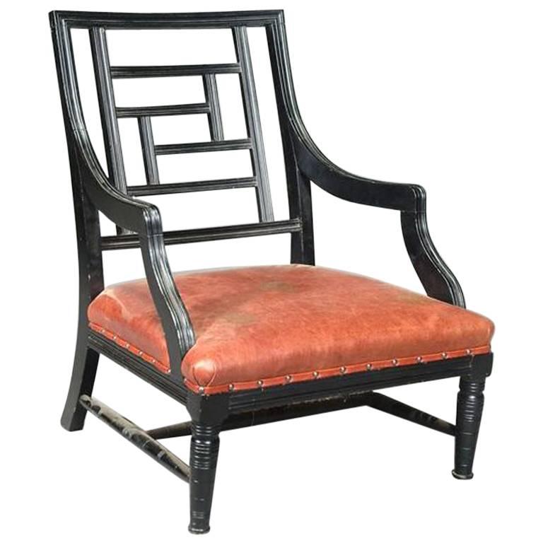 A Low Ebonized Elbow Chair, Attributed to E W Godwin. For Sale