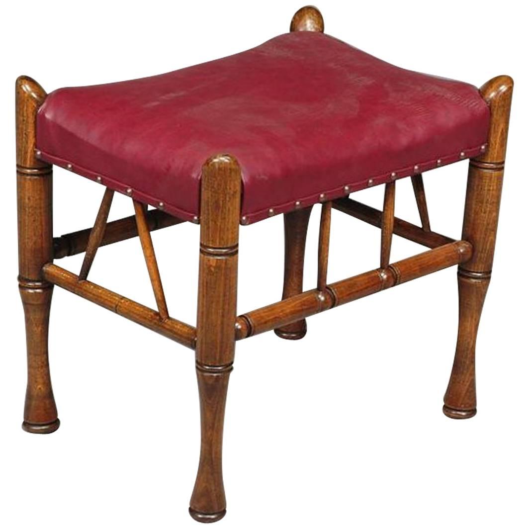 Liberty and Co. A Stained Beech and Leather Thebes Stool. For Sale