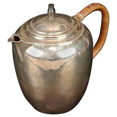 An Arts and Crafts silver ovoid covered jug, by W A S Benson