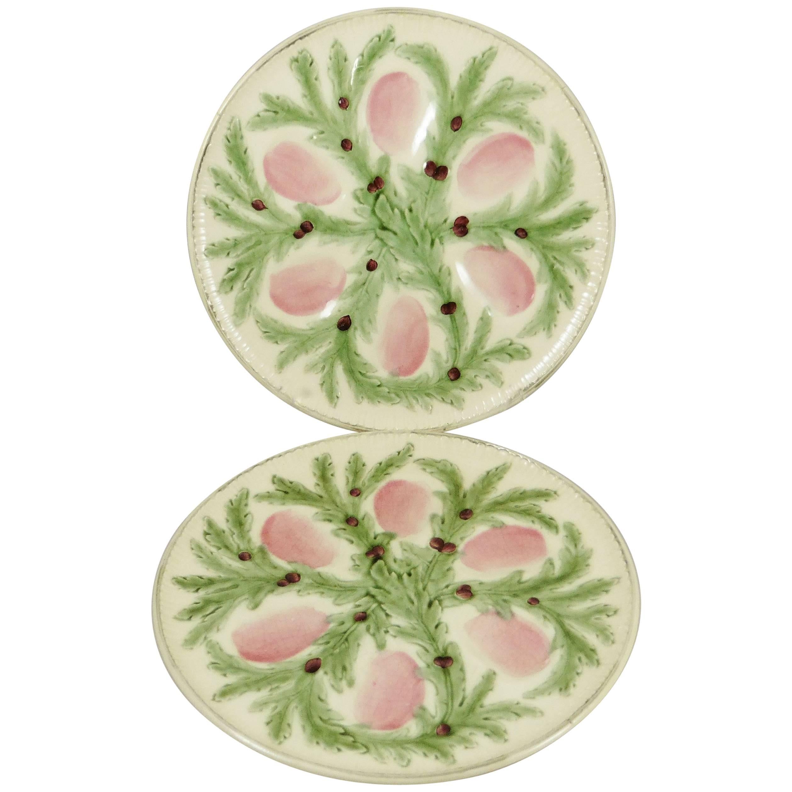 Very decorative Majolica oyster plate signed Hippolyte Boulenger Choisy le Roi. 2 plates available, 600$ each. The six pink wells are surrounded by green seaweeds.