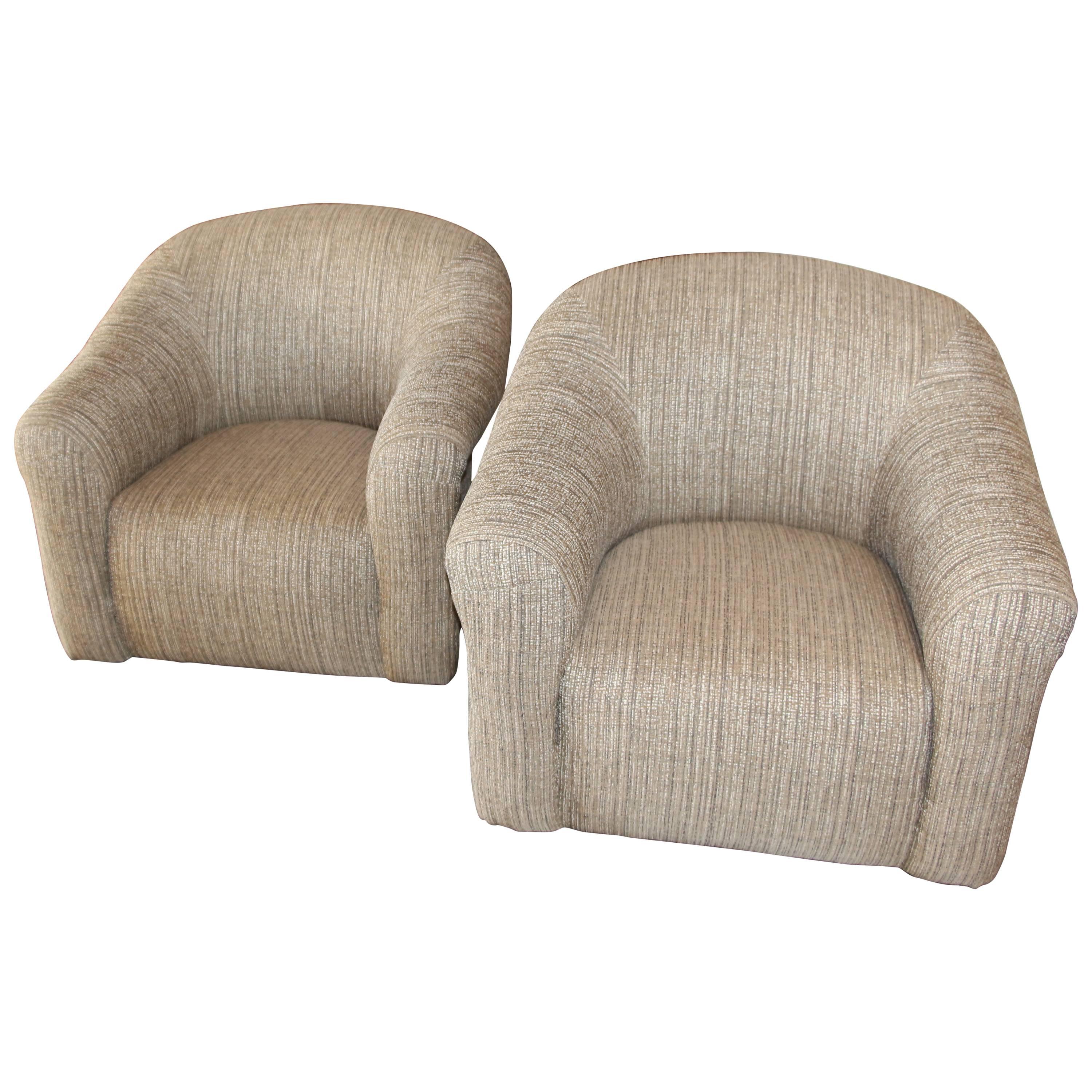 A nice pair of comfortable swivel A. Rudin chairs re-upholstered in a pretty Sina Pearson silk linen blend. Nicely redone with detailed stitching on he arms and gathered on the back. The ottomans are on ball casters as well. Ottomans are 26 x 19