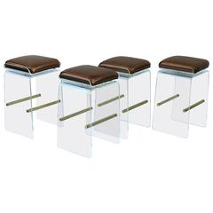 Set of Four Swivel Acrylic and Brushed Brass Barstools by Charles H. Jones