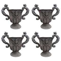 Set of Four Lead Urns with Cherubs