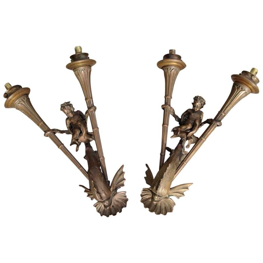 An exceptional pair Bronze wall lights of a Merboy riding a mythical Dolphin For Sale