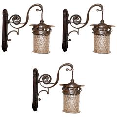 Six.Three pairs of Arts and Crafts hand made iron wall lights with mottled shade