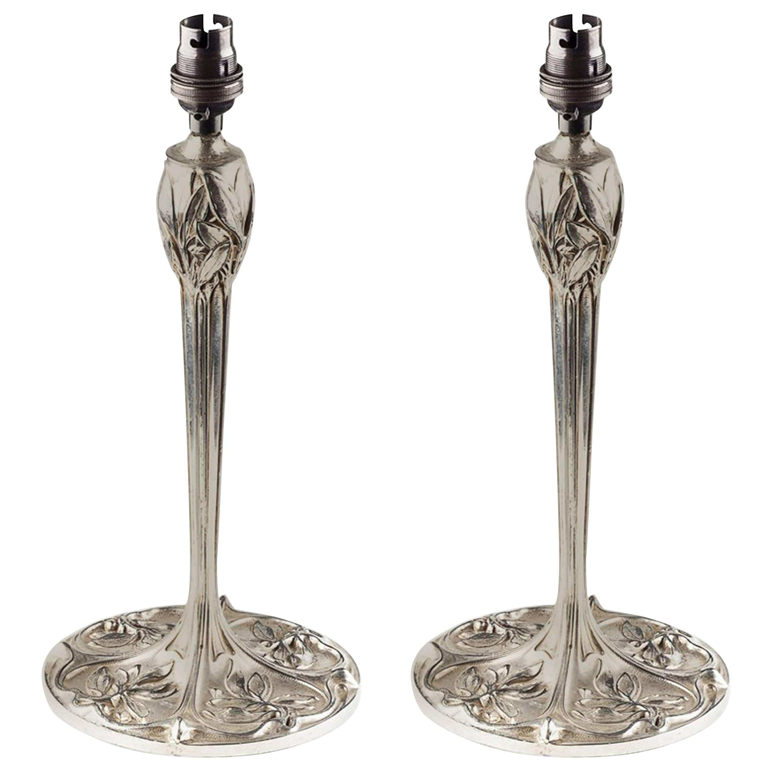 A Pair of Arts and Crafts Silver Plated Table Lamps With Stylised Floral Details For Sale