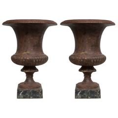 Pair of Iron Campaign Urns on Faux Marble Base