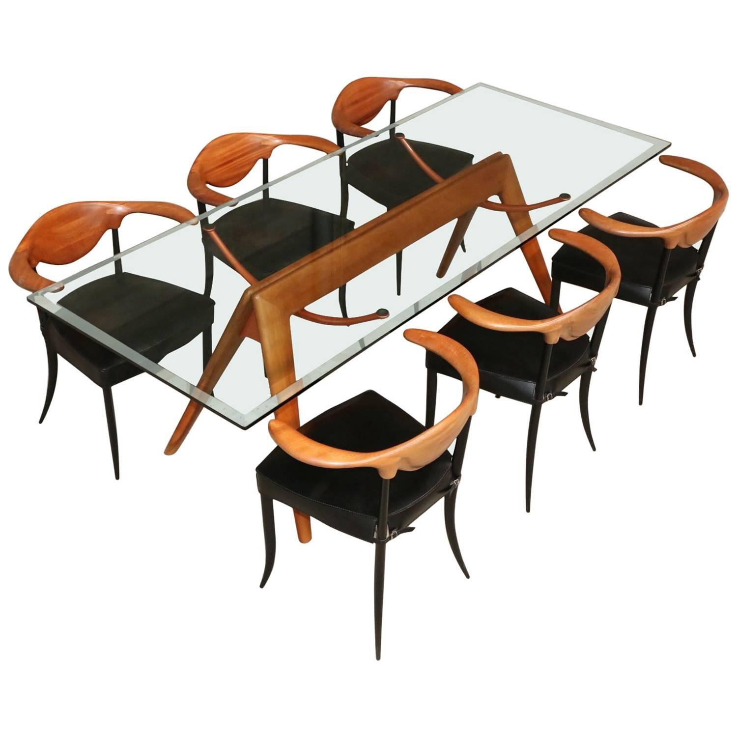 Impressive glass table with wooden base and six cowhorn chairs, Italy