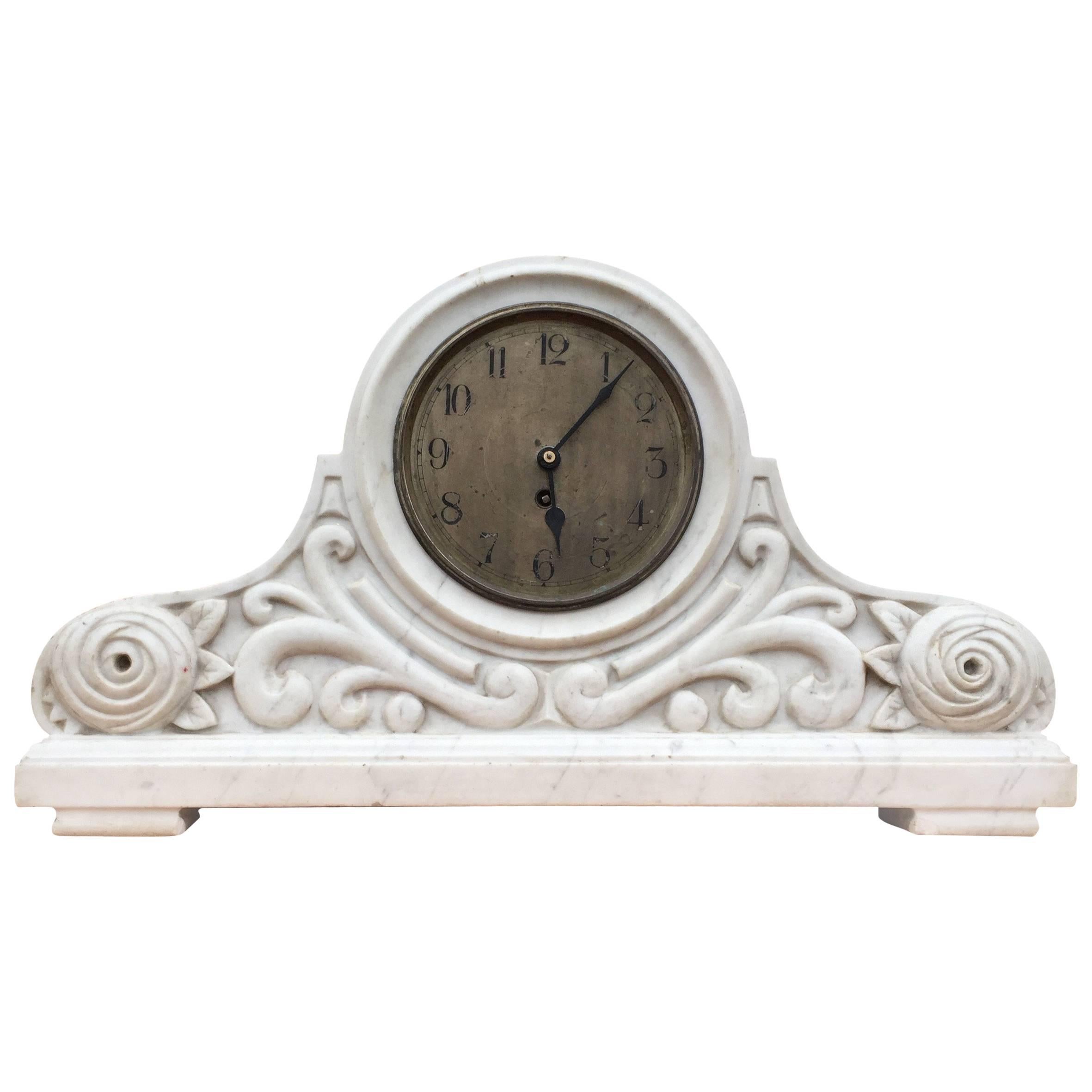 Unique and good size, hand carved solid marble mantel clock.

This beautiful and hand-carved timepiece is a rare find and the look and feel is extraordinary. You will only very rarely come across a hand-carved body like this and the white marble