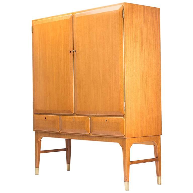 A beautiful high-quality cabinet by Bertil Fridhagen for Bodafors, Sweden. This piece is made of solid wood and features two large lockers and three drawers. The veneer is beautifully shaped in discrete angles on the doors and drawers, adding a