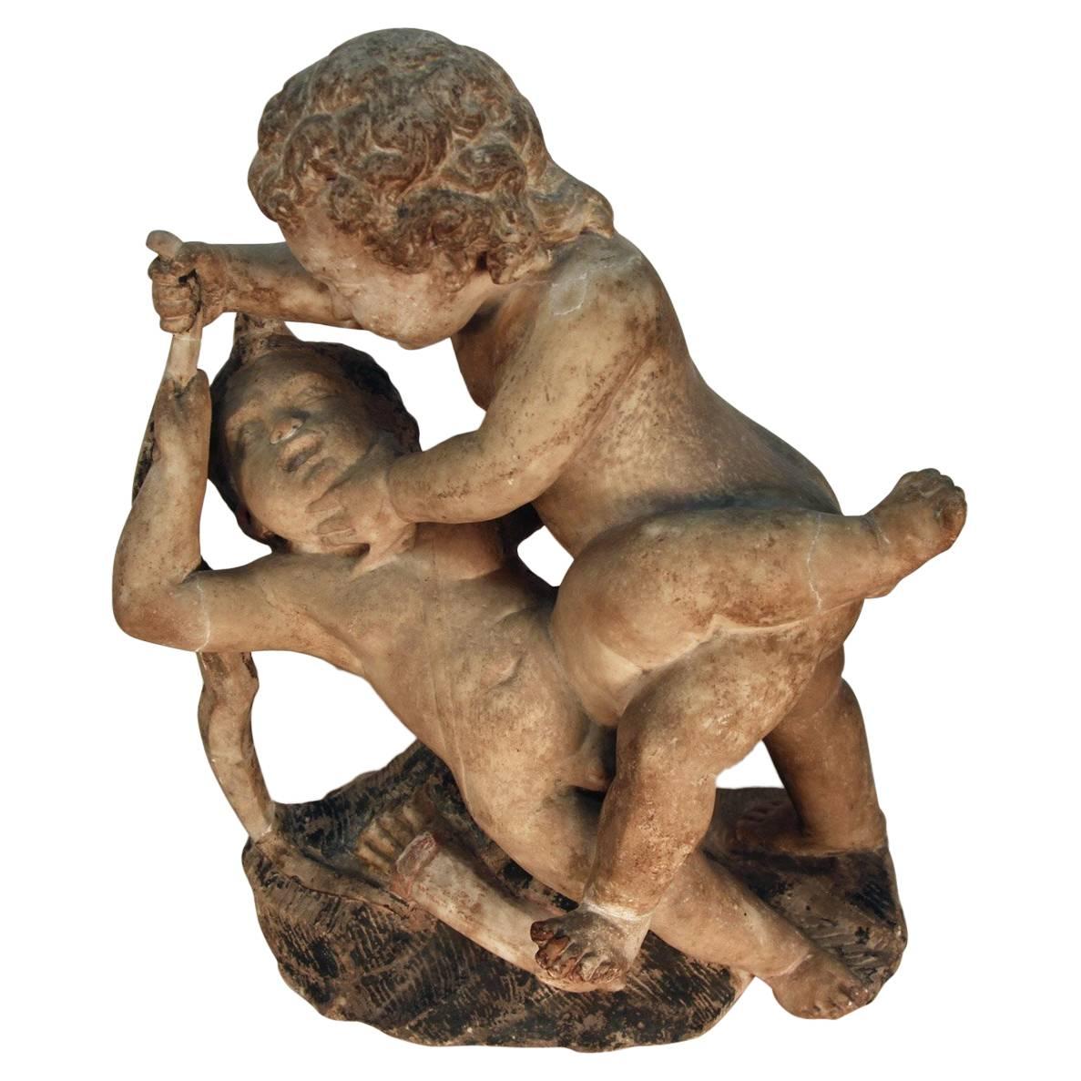 17th Century Sculpture of Putto at Play For Sale