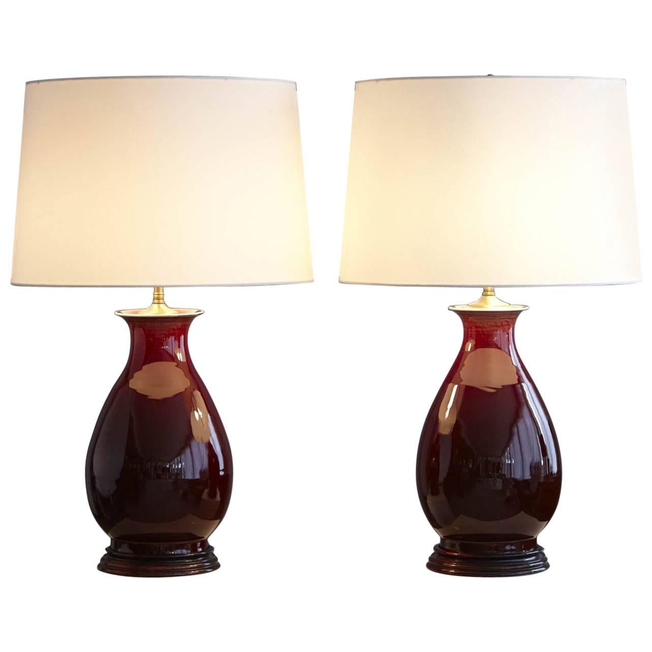 Pair of Deep Red Glazed Ceramic Lamps with New Ivory Shades, Height Adjustable