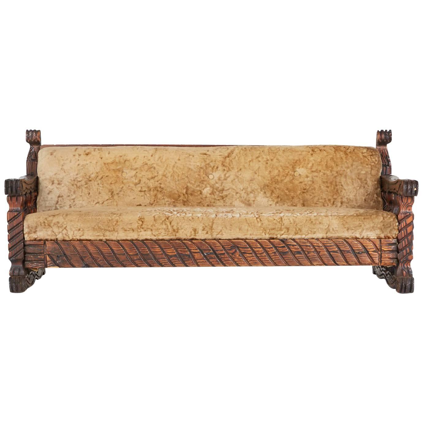 This ornately crafted red walnut tufted sofa with carved exotic details is a testament to William Westenhaver's modern primitive creations. Westenhaver joined forces with Western International Trading Company (Witco) in 1957 to bring his vision of