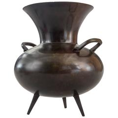 A Japanese Brown Patinated Bronze Pot with Handles and Three Feet