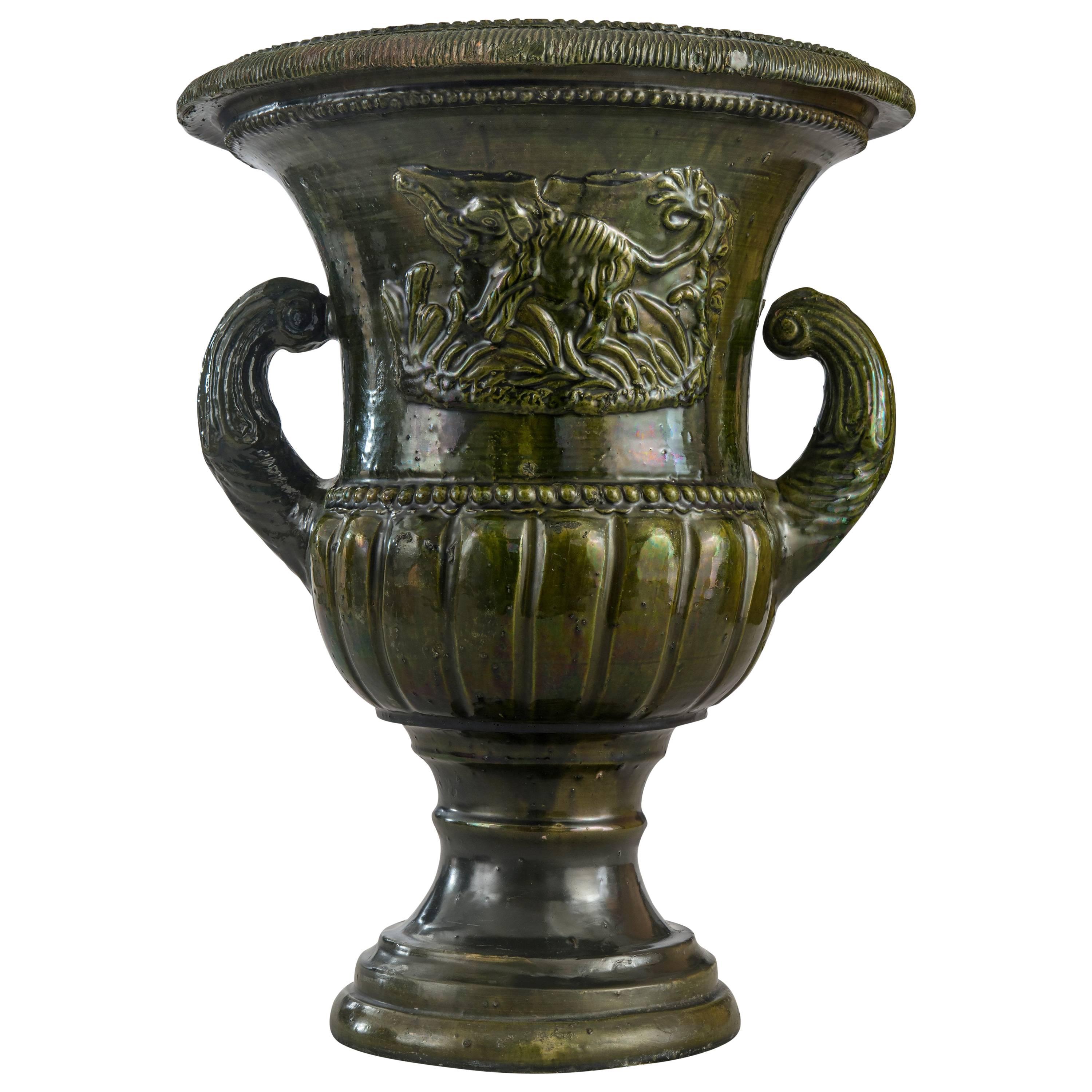 A French Green Glazed Faience Campana Urn with Elephant Relief For Sale