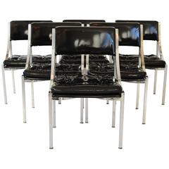 Set of Six Mid-Century Polished Chrome Chairs. Covered in black patent leather