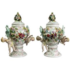 Antique Pair of Meissen Polychrome Figural and Floral Lidded Urns with Cherubs