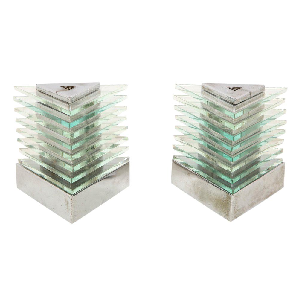 Maison Desny table lamps, nickel-plated metal and glass, signed. Small scale triangular shaped table lamps with plated columns and stacked glass. Minor wear to the nickel plated metal and some minor chipping to glass. Both lamps have been rewired