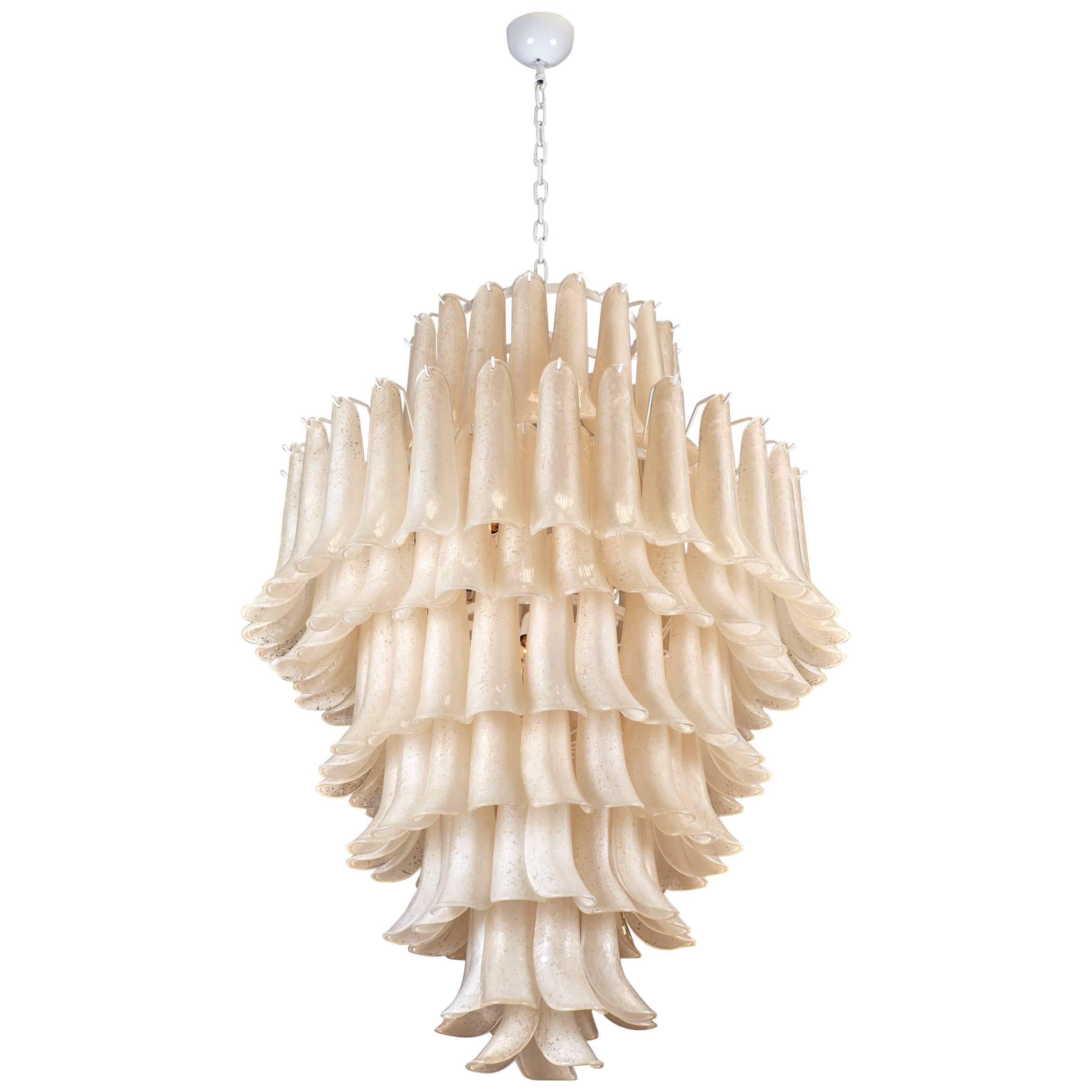 Stunning chandelier made of Murano glass pieces overlapping to create a feathered effect. The handblown glass was created using the 'Scavo' technique, leaving the pieces to have an etched or corroded finish on one side. This beautiful chandelier has
