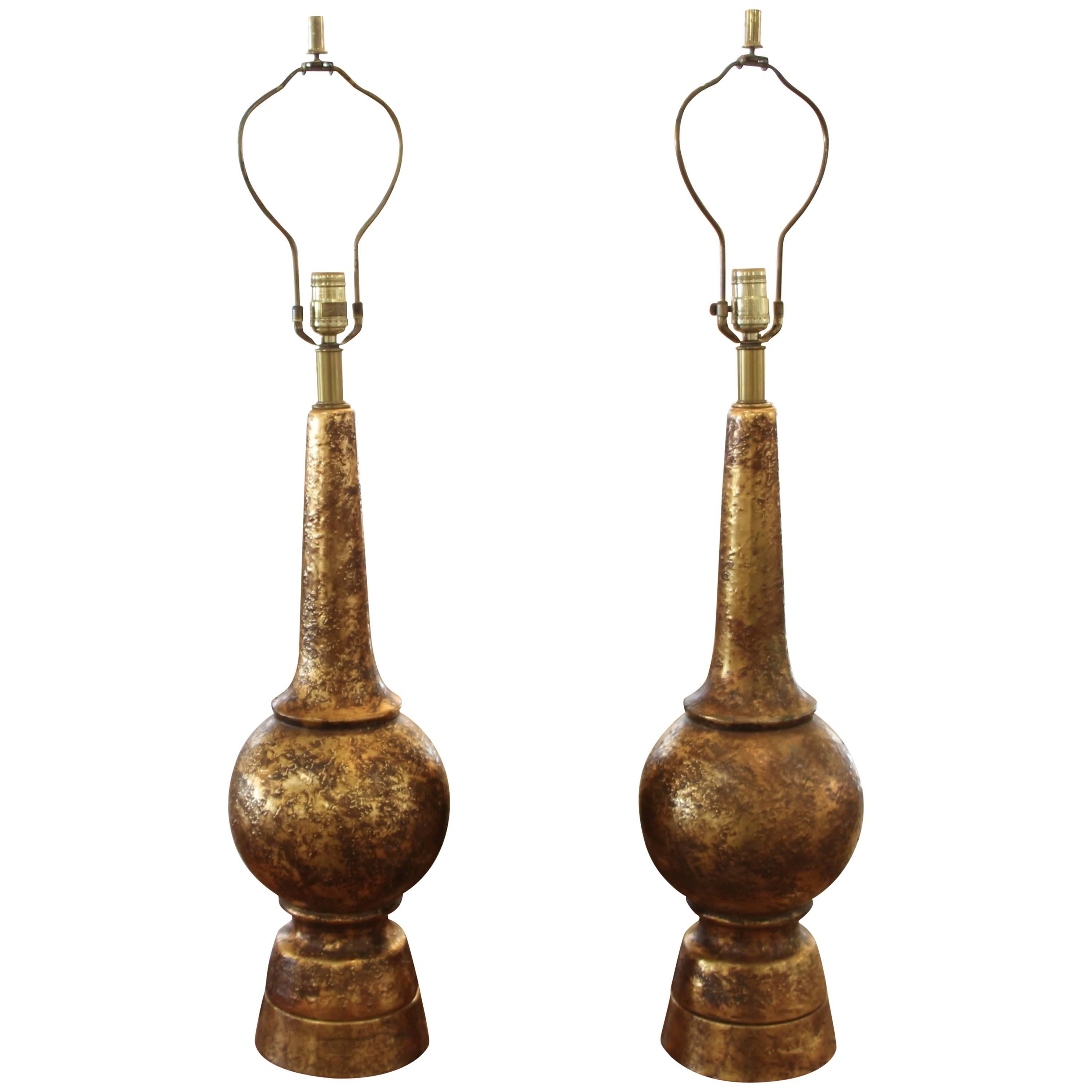 A nice pair of Nardini lamps in patinated brass iron base and brass bodies. these lamps are in working order. They stand quite tall at 38 inches to the finial top and 29 inches to top of lamp socket. They are 8 inches in diameter. The shades