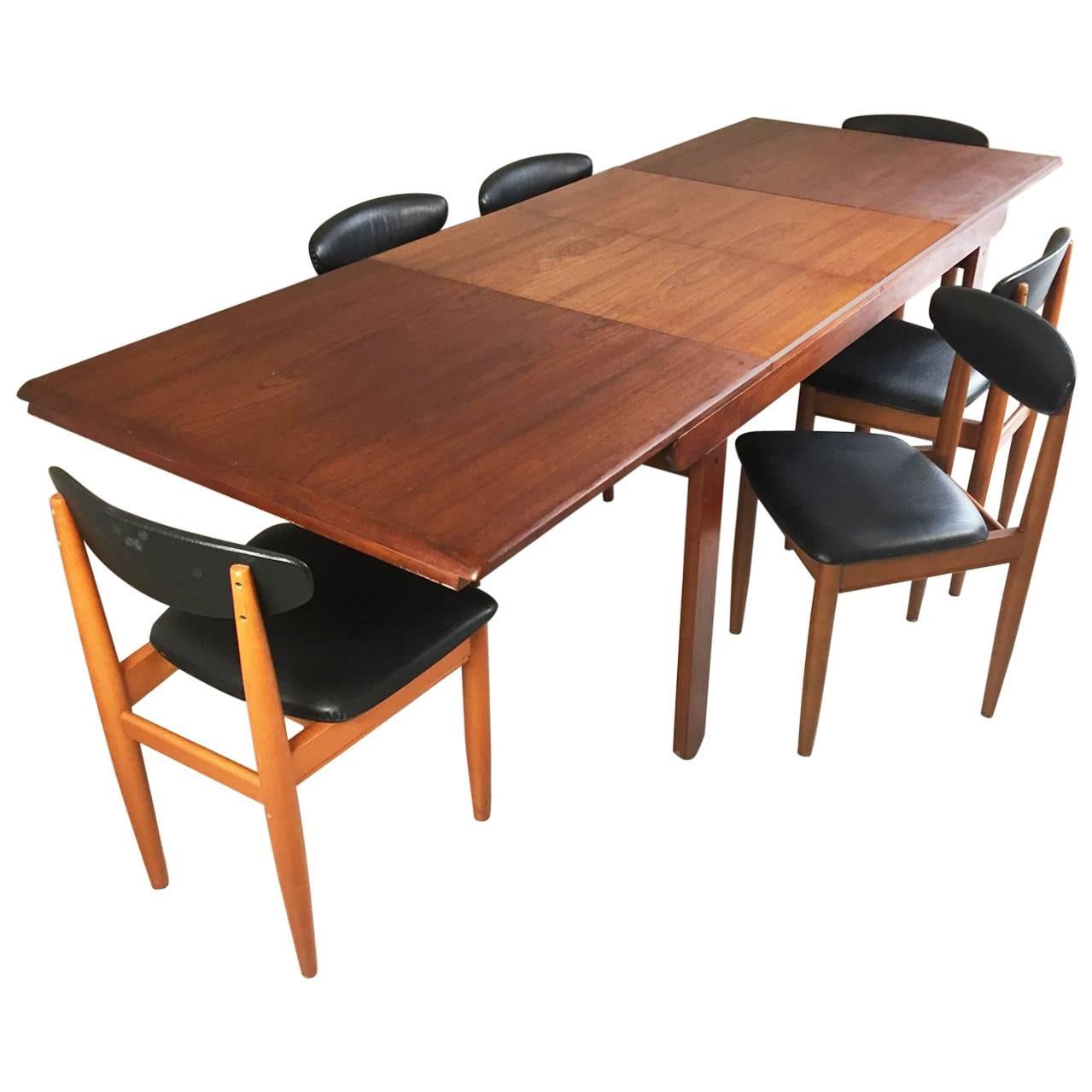 1970s Mid-Century Teak Extendable Dining Table and Six Black Vinyl Chairs