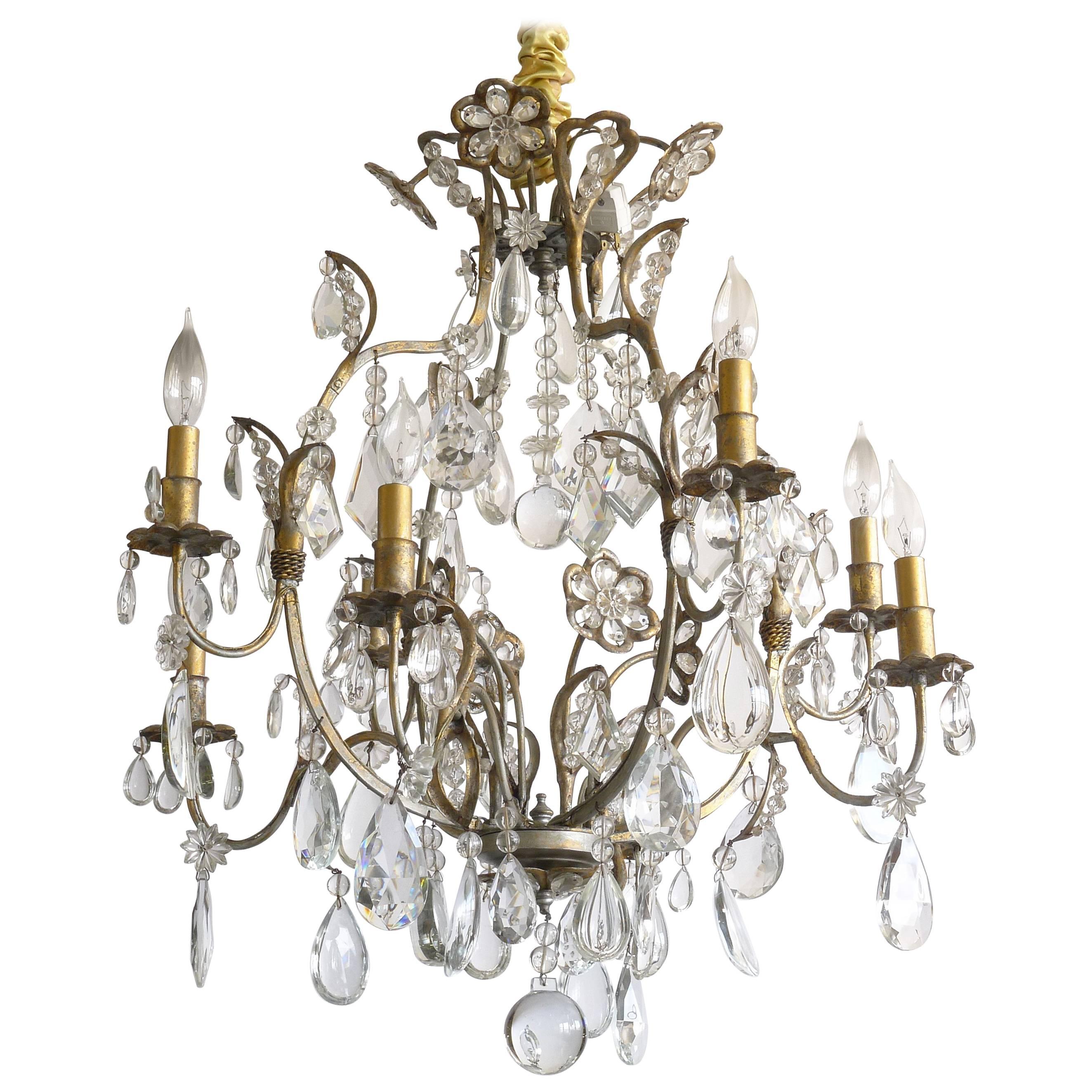 Hollywood Regency Gilt Decorated Wrought Iron and Crystal Eight-Arm Chandelier For Sale