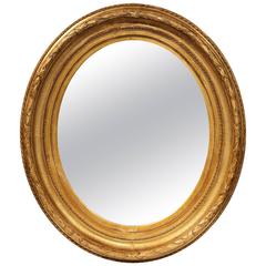 19th Century French Louis XV Carved Giltwood Oval Mirror