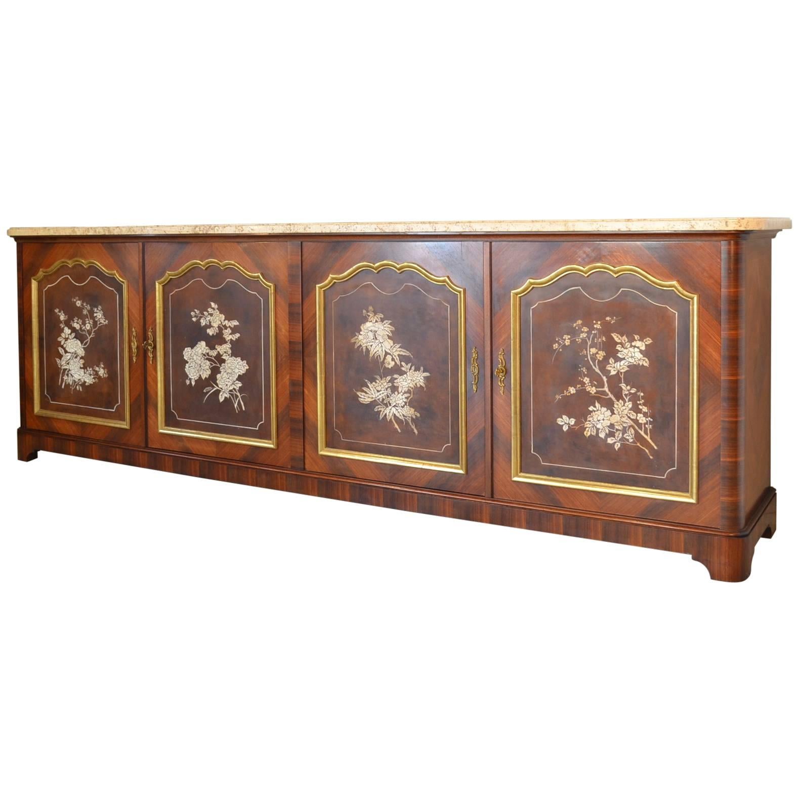 A large French Maison Jansen four door sideboard with travertine top. Marquetry veneer of mahogany with decorative painted panels on the doors. Two keys with working locks. A handsome piece with great proportions. Please note the large-scale at