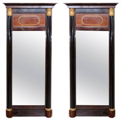 Pair of Baltic Neoclassic Mahogany Ebonized Parcel-Gilt Mirrors