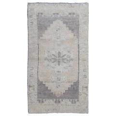 Muted Vintage Oushak Carpet with All-Over Diamonds and Sprays of Vine Scroll
