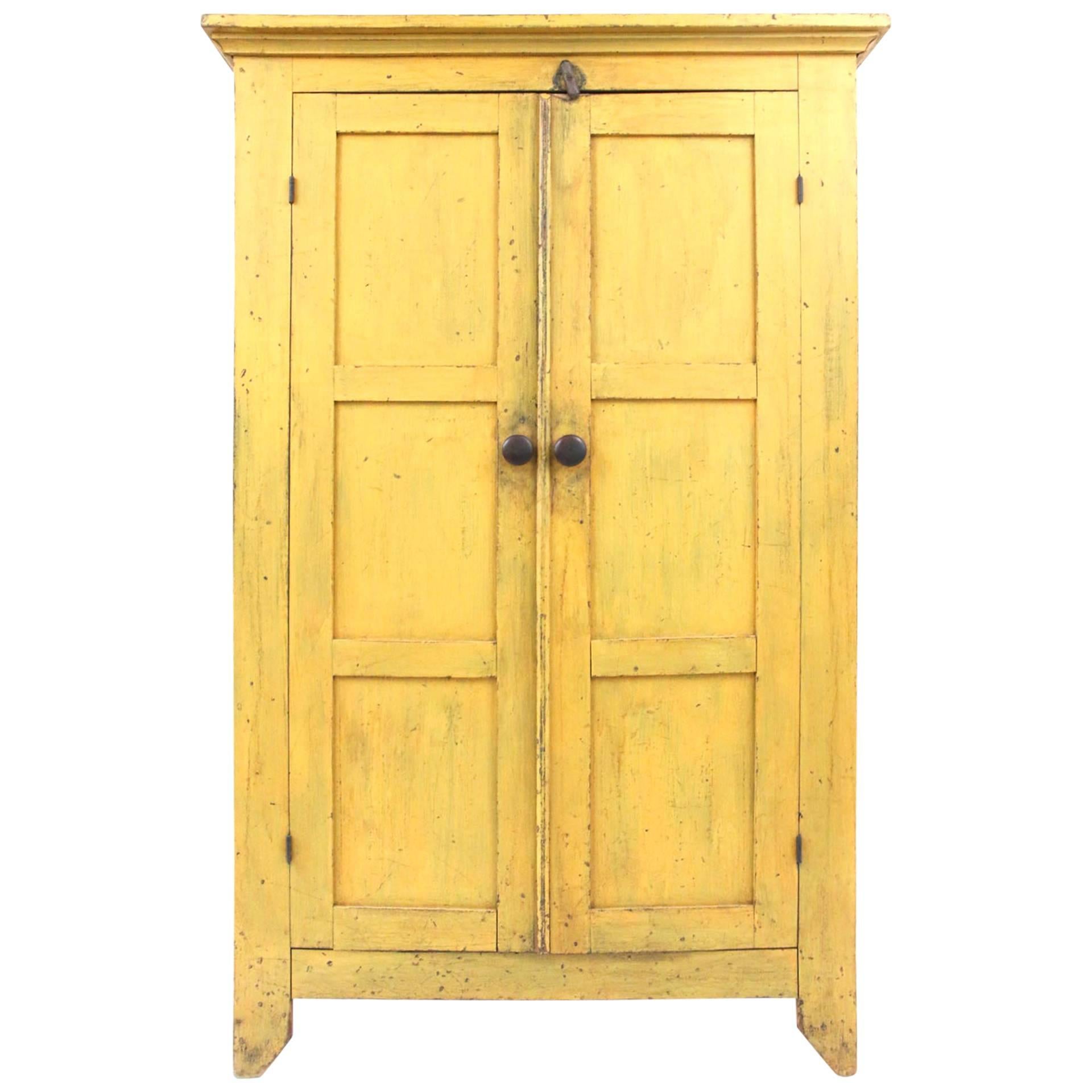 19th Century New England Chrome Yellow Cupboard with Panelled Doors For Sale